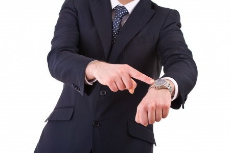 A person pointing to their watch